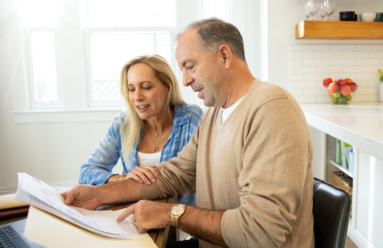 Couple looking over papers at table